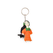 Doll Keychain with a figurine of a woman in a orang dress 