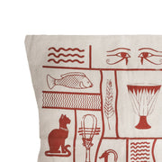 Decorative pillow with burgundy hieroglyphic patterns on a beige background